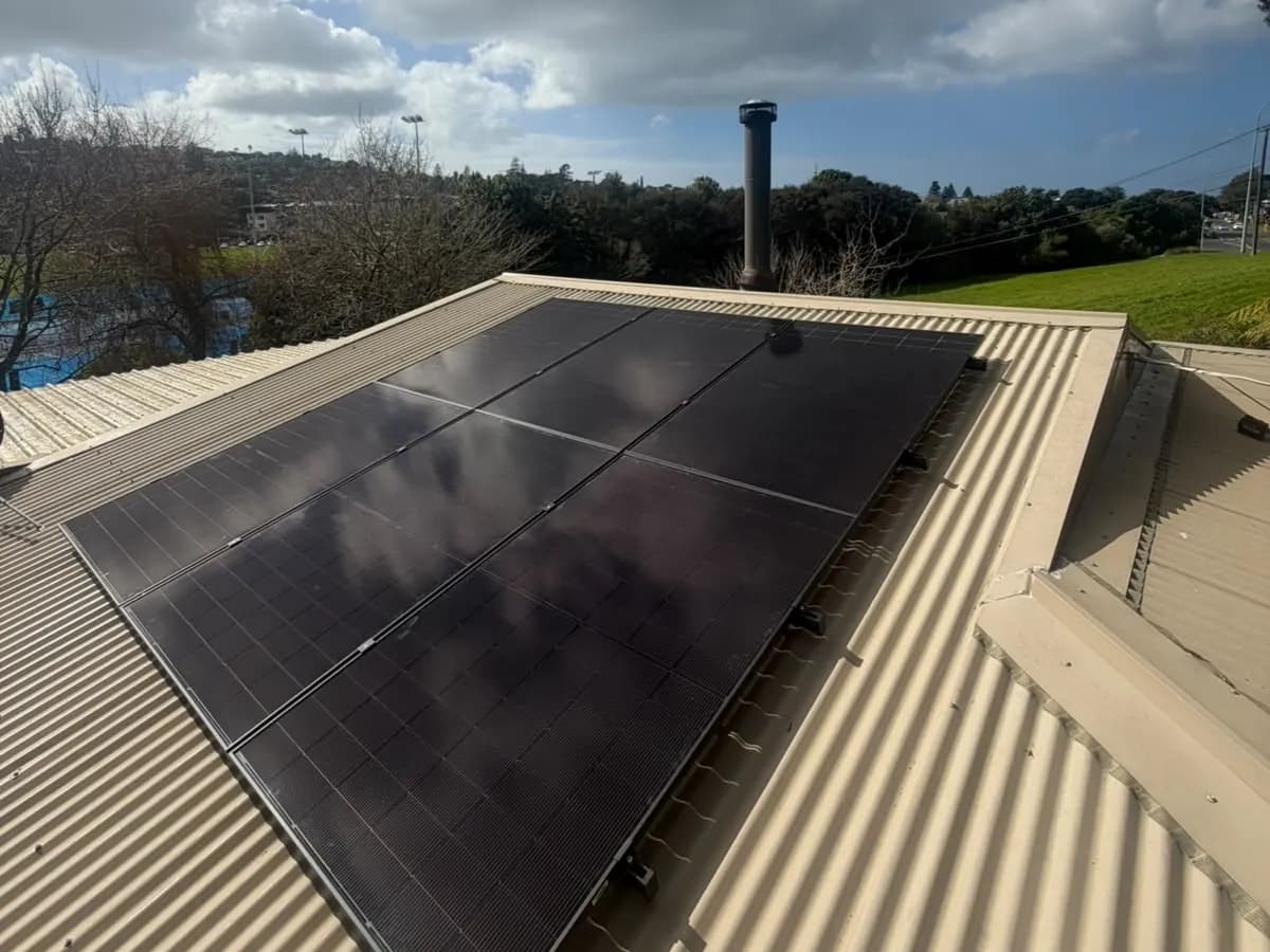 A 6.8kW EFS Solar array on a home in Browns Bay, Auckland, reserve behind