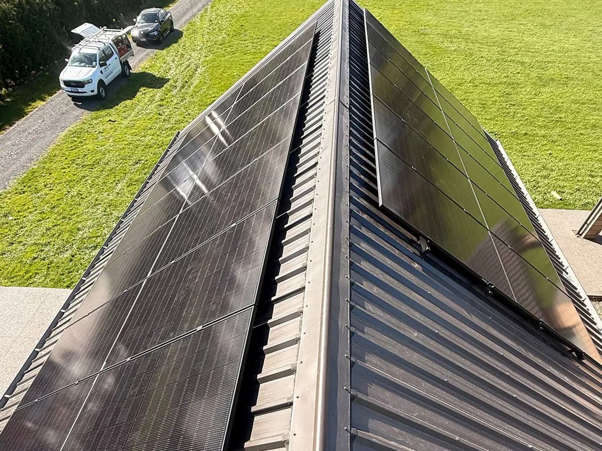 An 11.7kW EFS Solar array on both faces of a charcoal metal roof at a rural Cambridge property, Waikato