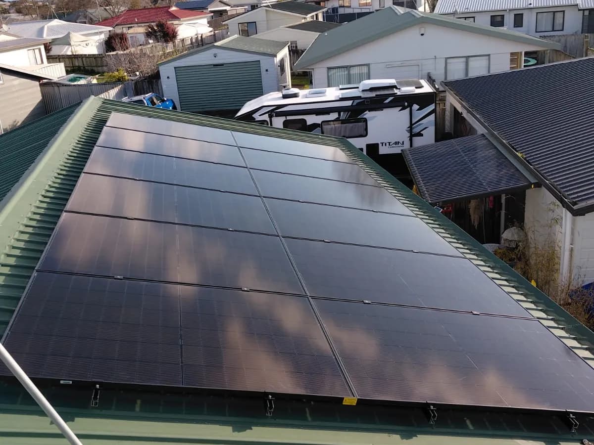 A 10.9kW EFS Solar array on a green metal roof in Hamilton, Waikato, on a suburban street
