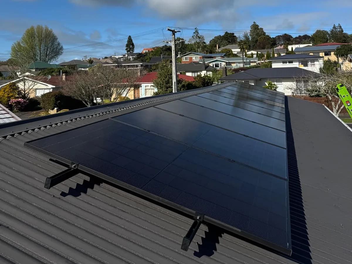 A 5.2kW EFS Solar array on a dark metal roof in Hamilton, Waikato, on a suburban hillside