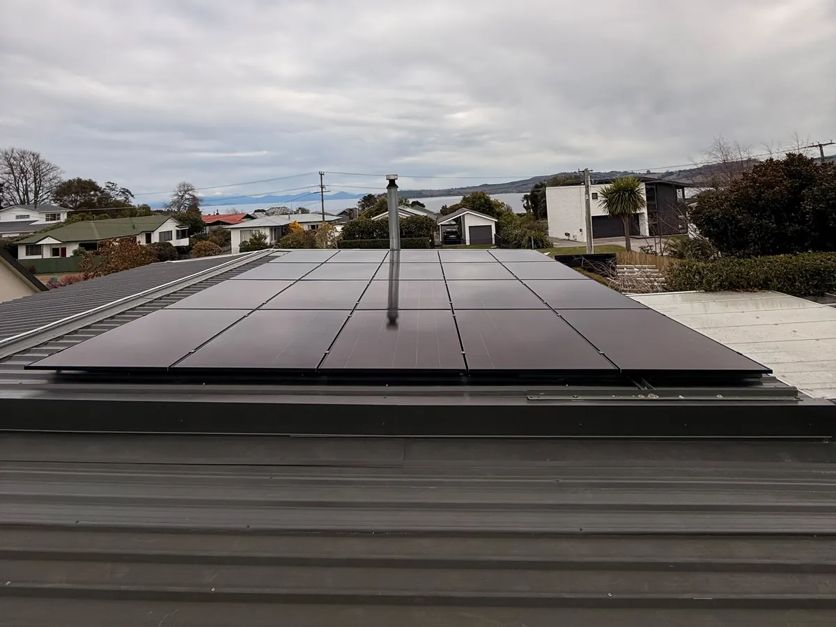 A 9.1kW EFS Solar array on a home in Hilltop, Taupō, with Lake Taupō behind