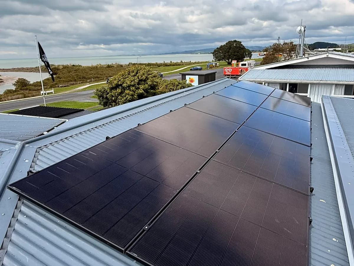 A 7.28kW EFS Solar array on a metal roof at Kaiaua, Waikato, with the Firth of Thames behind