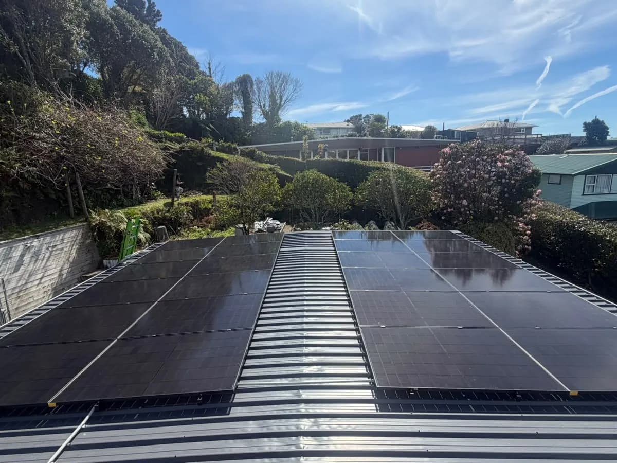 A 10.92kW EFS Solar array on a metal roof in New Plymouth, Taranaki, on a garden hillside