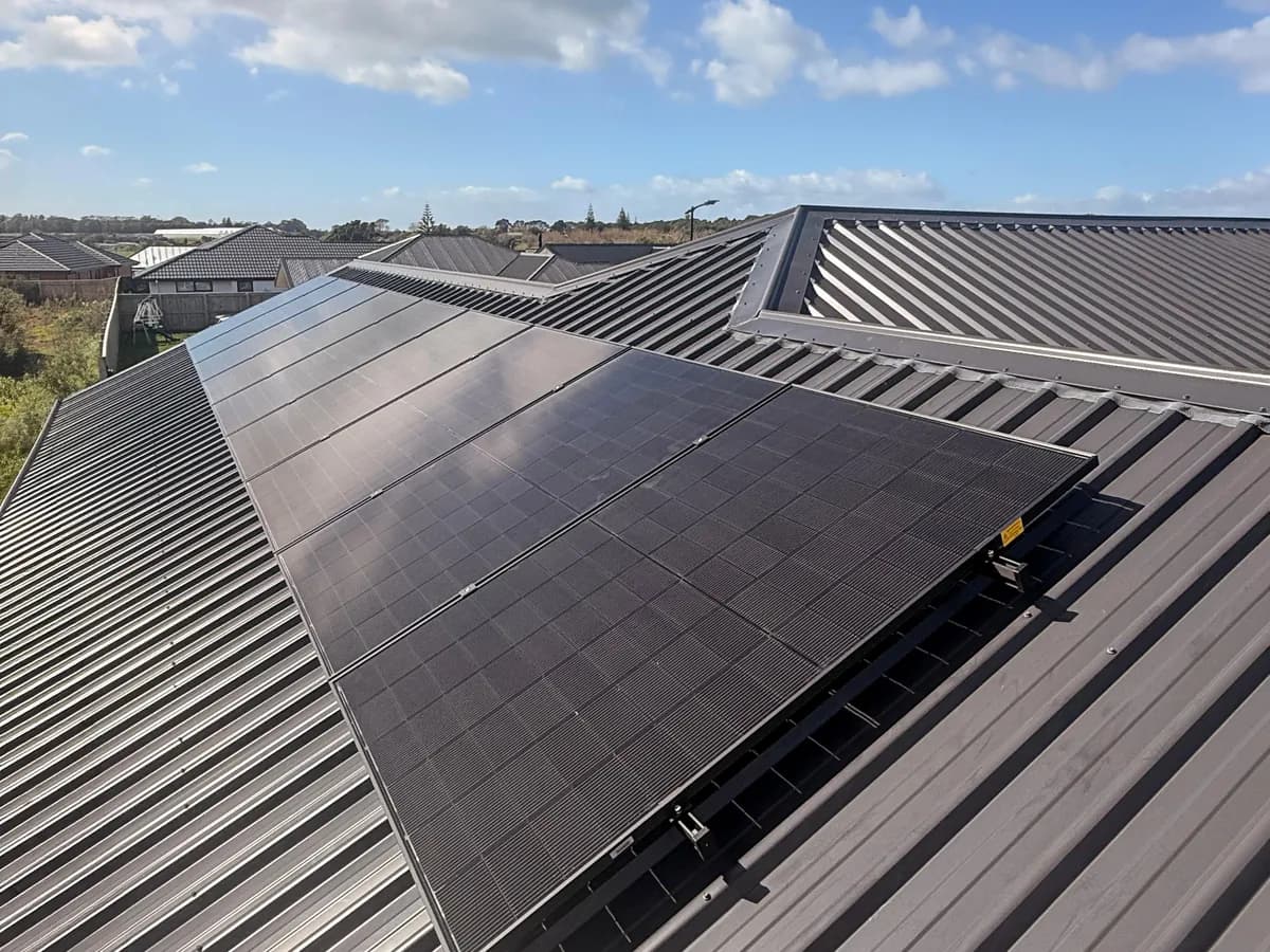 A 6.83kW EFS Solar array on the grey metal roof of a home in a New Plymouth subdivision, Taranaki