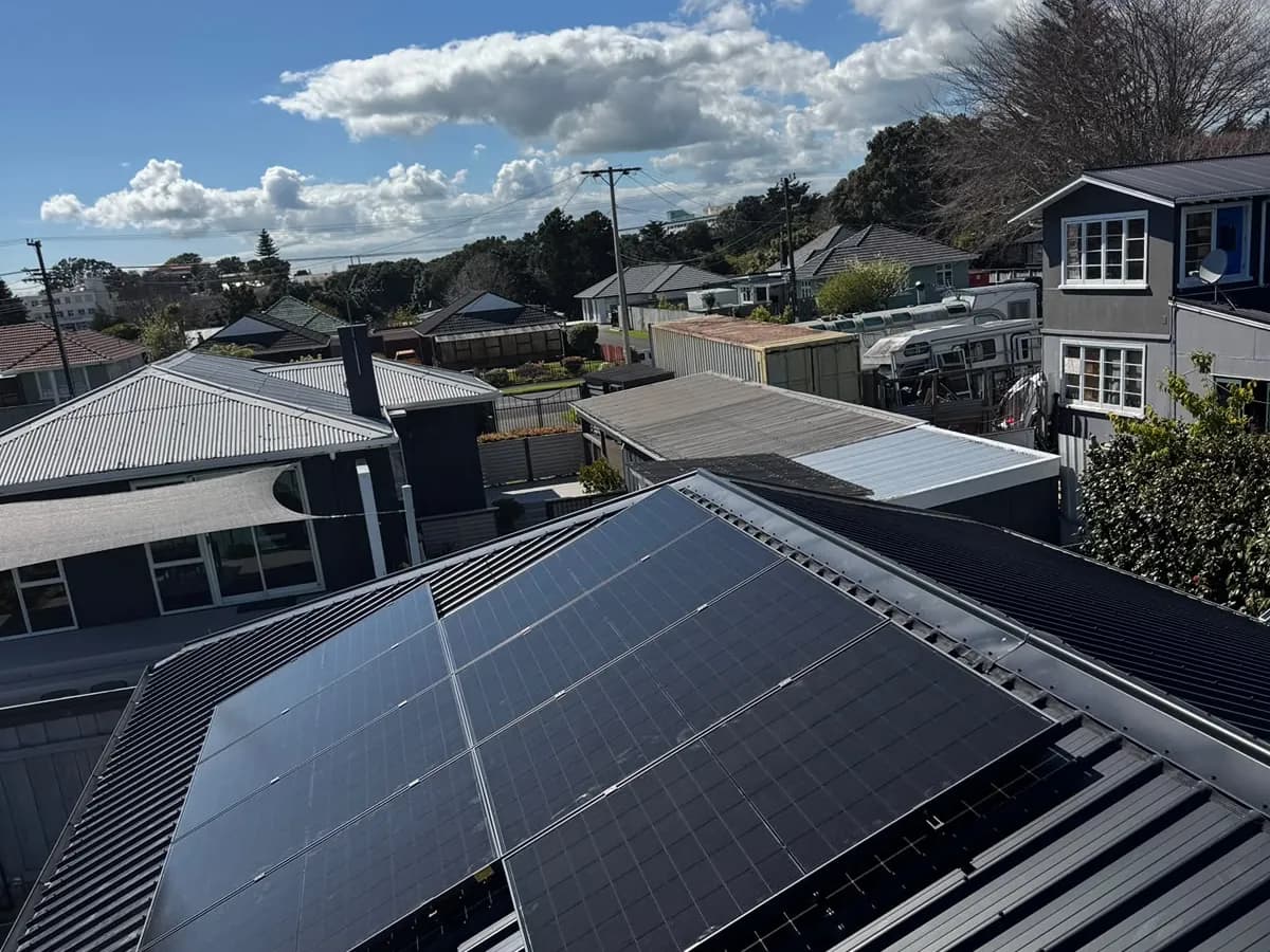 A 6.83kW EFS Solar array on a dark metal roof in a New Plymouth suburb, Taranaki