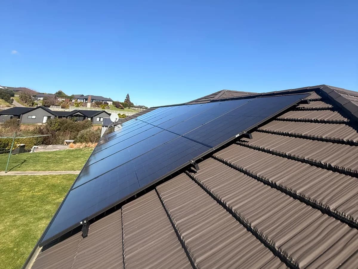 A 13.65kW EFS Solar array on a tile roof at Ōhaupō, Waikato, with the village behind
