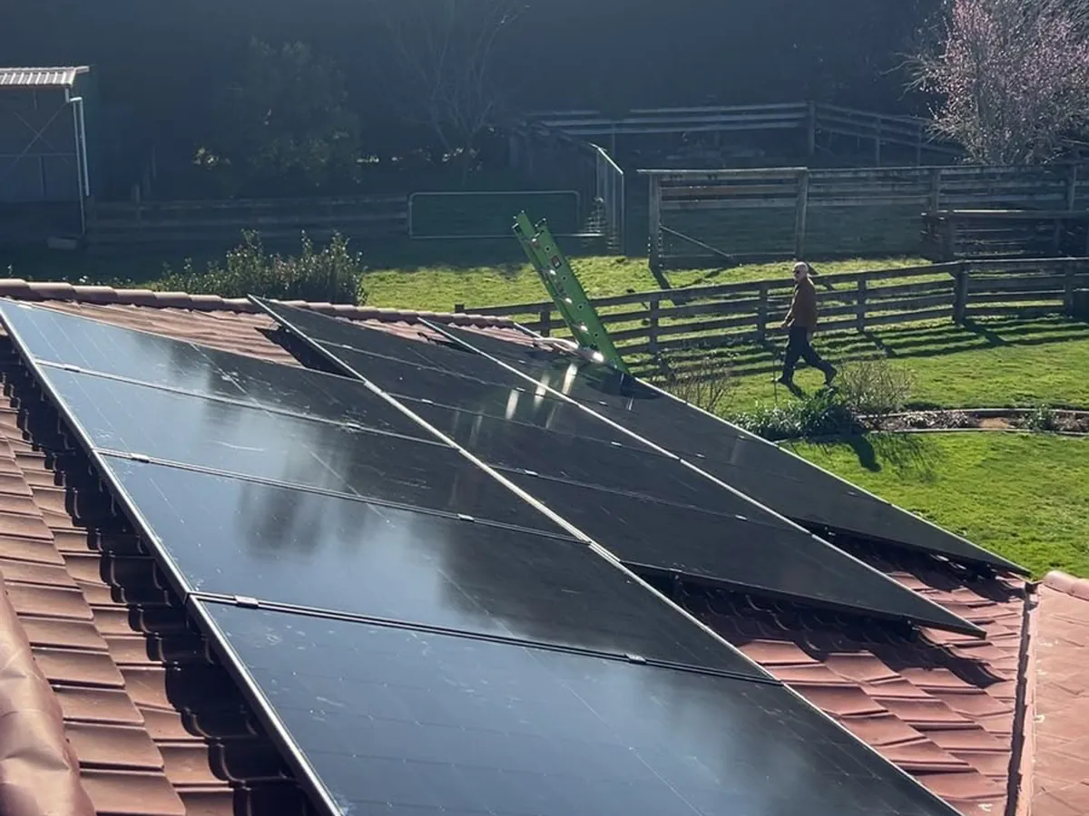 A 9.1kW EFS Solar array on the tiled roof of a rural home at Rukuhia, Waikato, paddocks behind