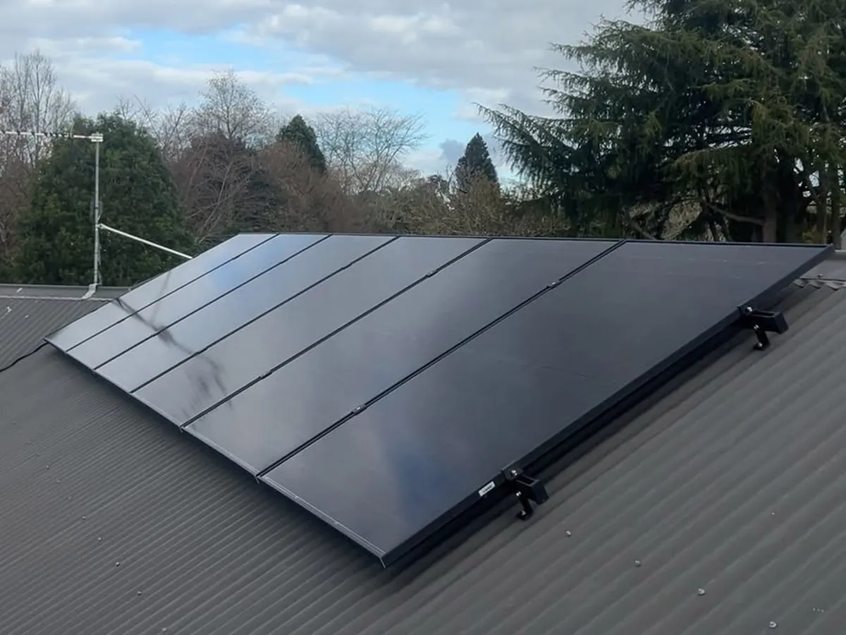 A 9.1kW EFS Solar array on a low metal roof at Tamahere, Waikato, cedar and trees behind