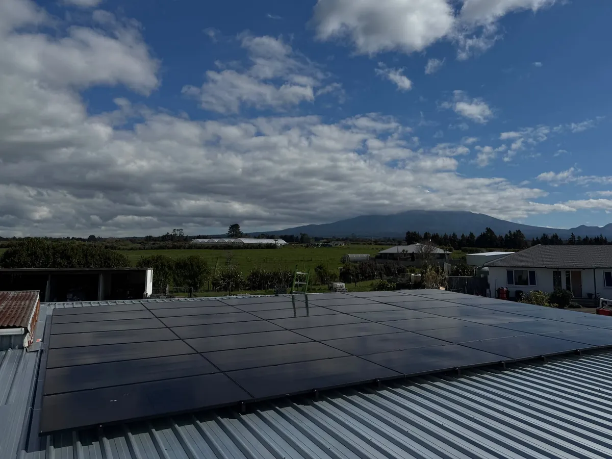 A 19.95kW EFS Solar array on a metal roof at a rural Tariki property, Taranaki, with Mount Taranaki behind