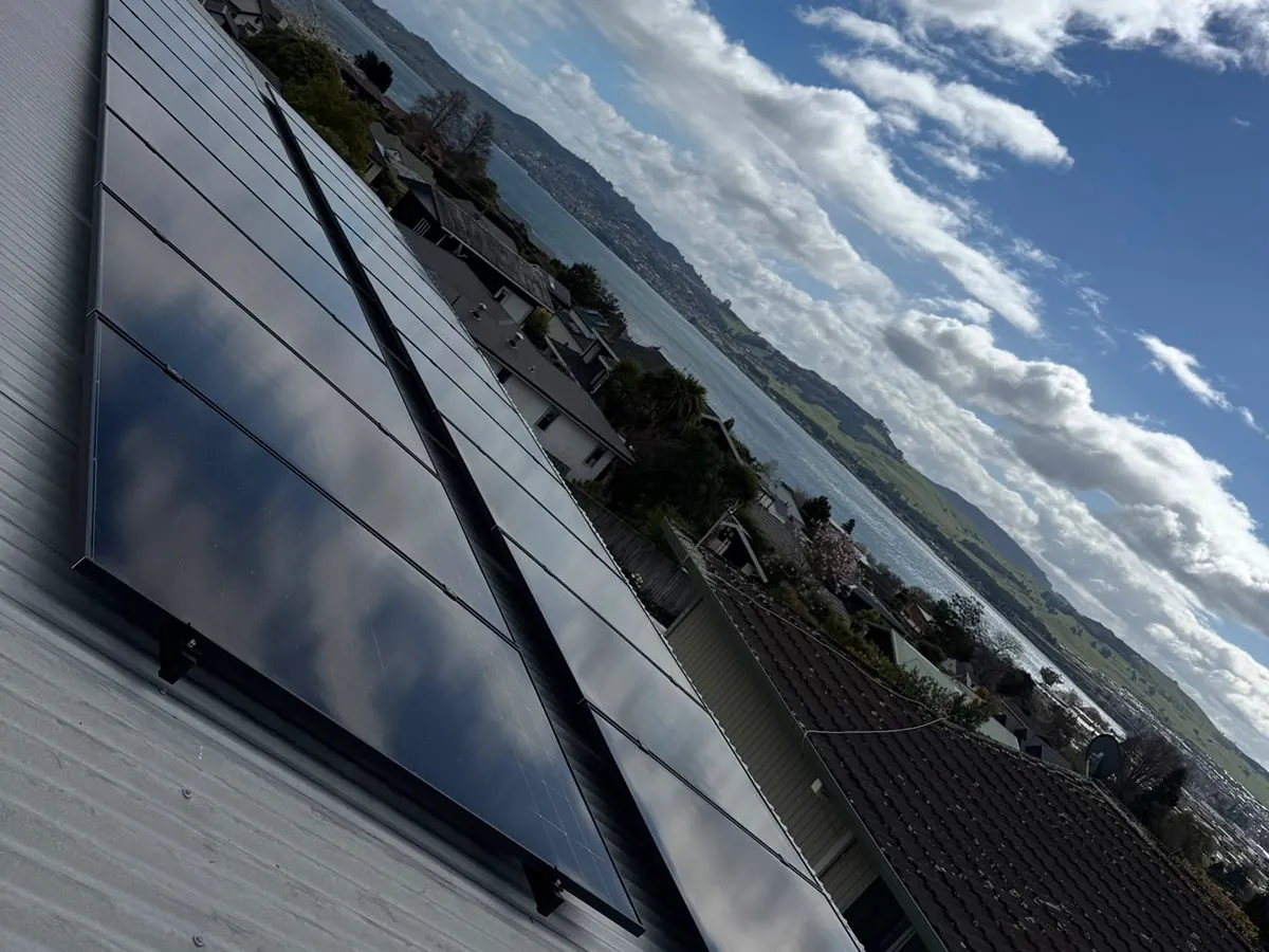 A 9.1kW EFS Solar array on a home in Taupō, Waikato, with a lake view behind