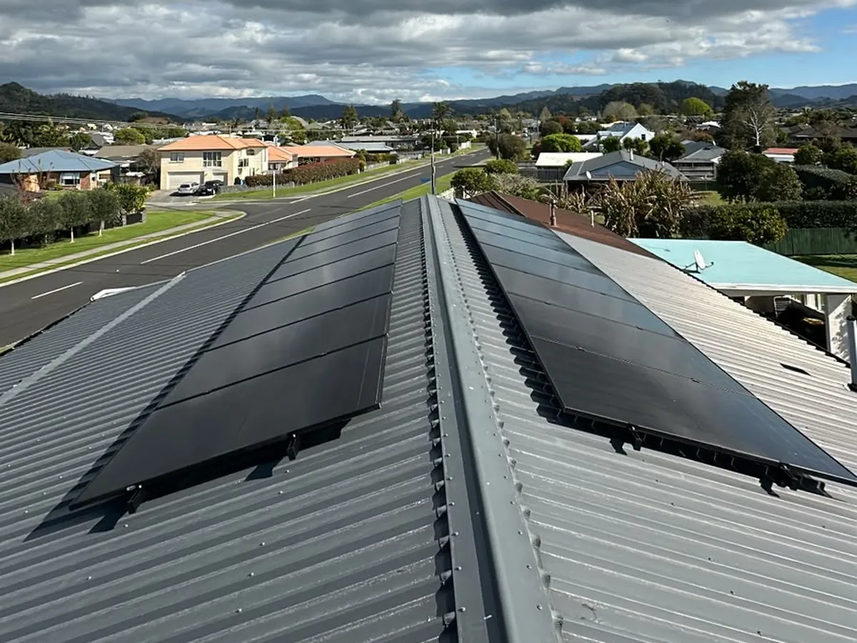 A 6.6kW EFS Solar array on a metal roof in Whitianga, Waikato, with the town and hills behind
